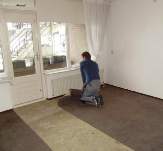 Verwijdering van het oude tapijt in mijn toekomstige studeerkamer. Buiten het plaatsje op de begane grond en erachter het sluisje naar de Merwede