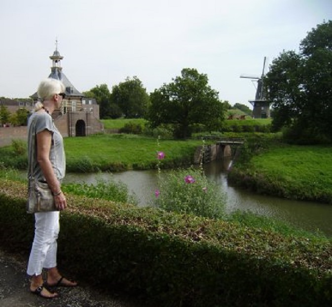 Wandelen over de stadswallen. Links de Dalempoort, rechts stadsmolen De Hoop
