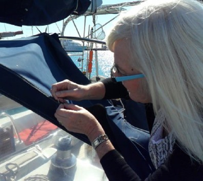 Ans repareert zelf de losgescheurde naad van de buiskap