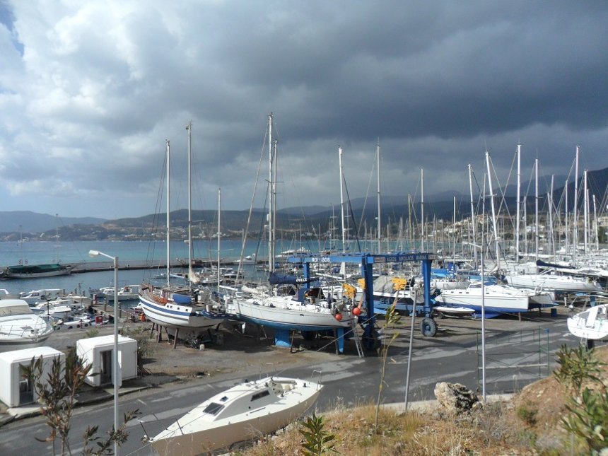 Dulce op de wal in Aghios Nikoláos. Rechts naast ons staat de kraan van Roussos geparkeerd. Rechts de beide toiletgebouwtjes.
