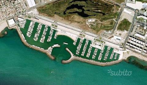 Luchtfoto van de haven. We liggen links aan de middelste steiger, aan de rechterzijde, vier boten vanaf het eind